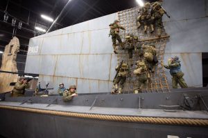 army men climbing boat