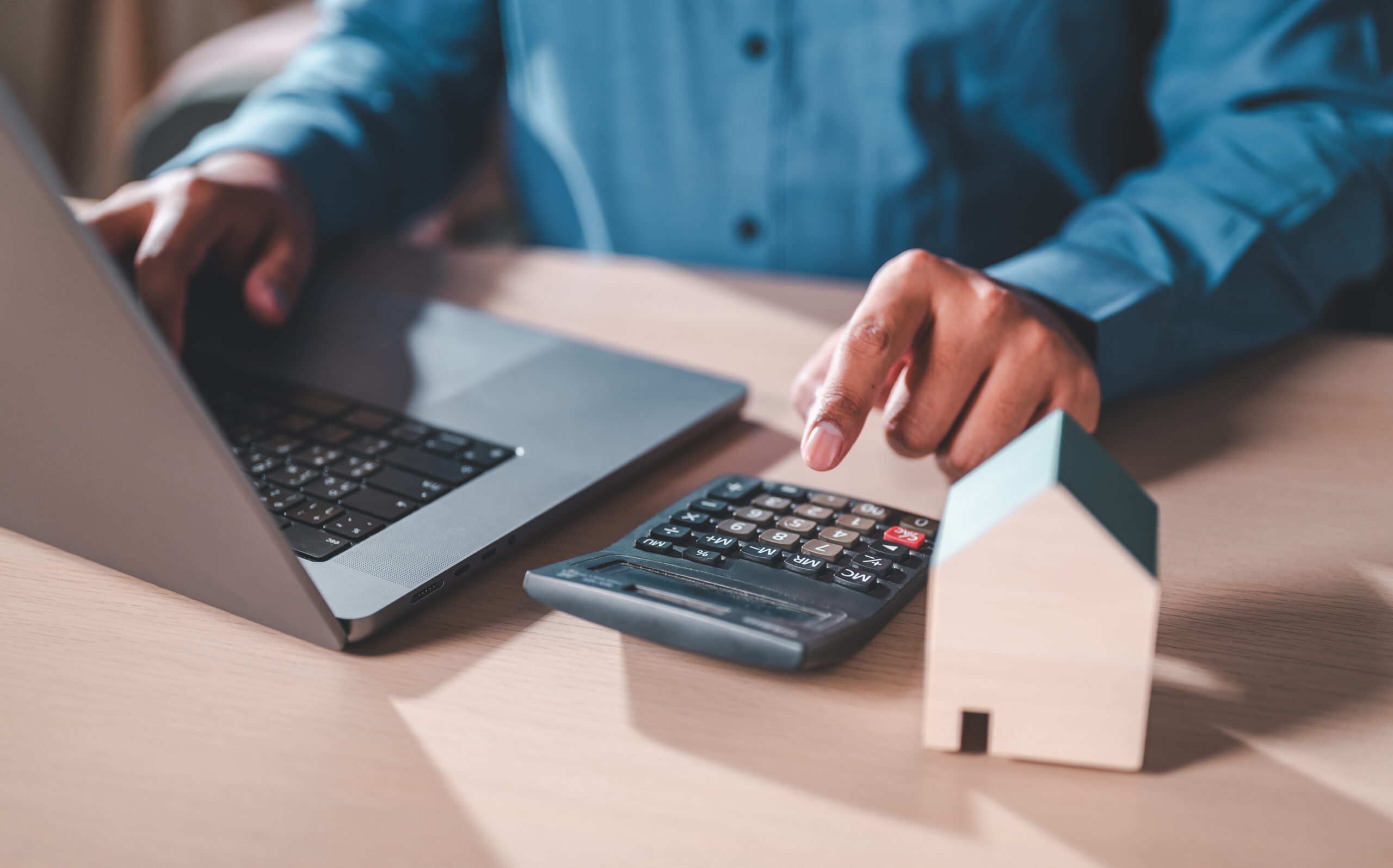 man calculates rent on calculator